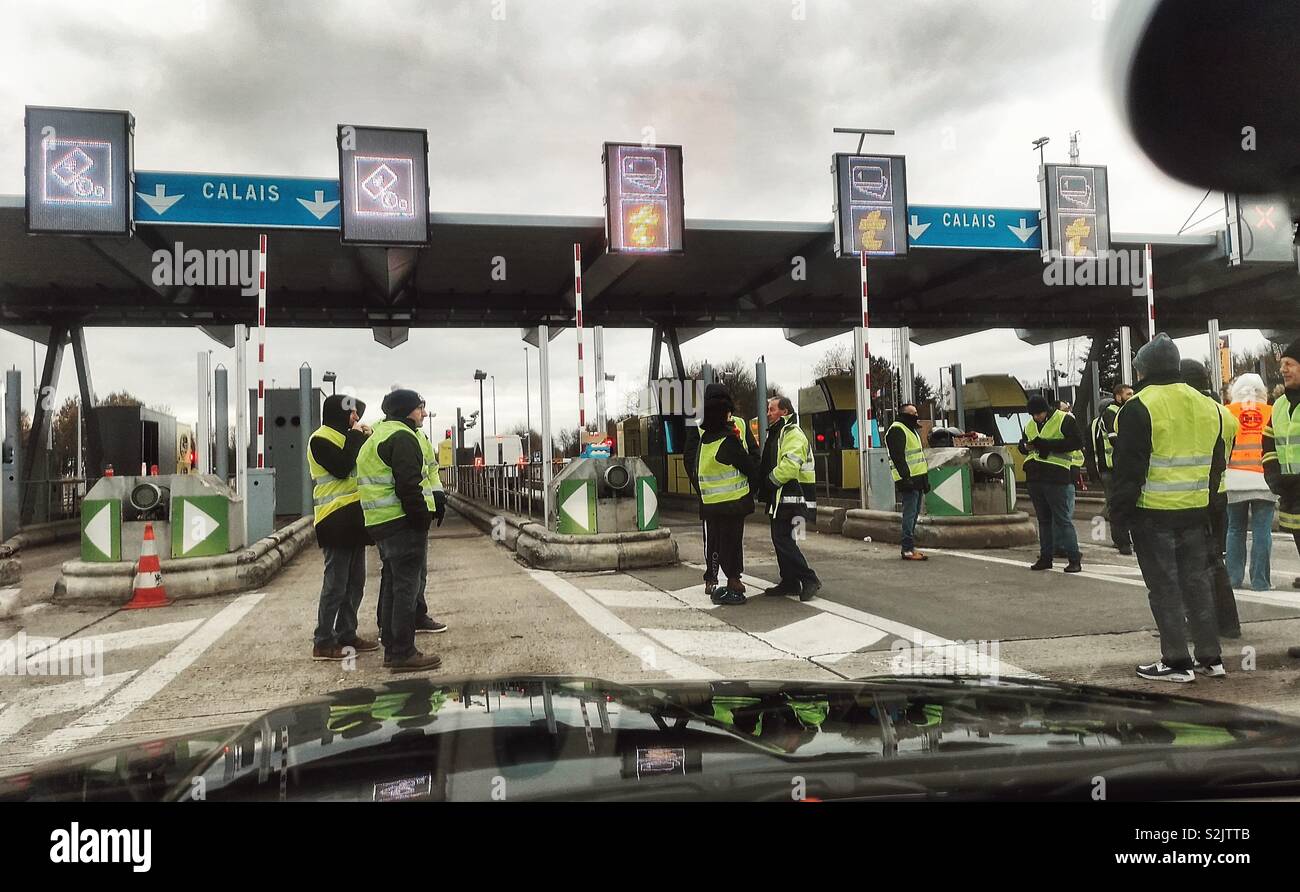 Gilets jaunes protestors at motorway toll gates, Northern France - Smartphone Captured Stock Image
