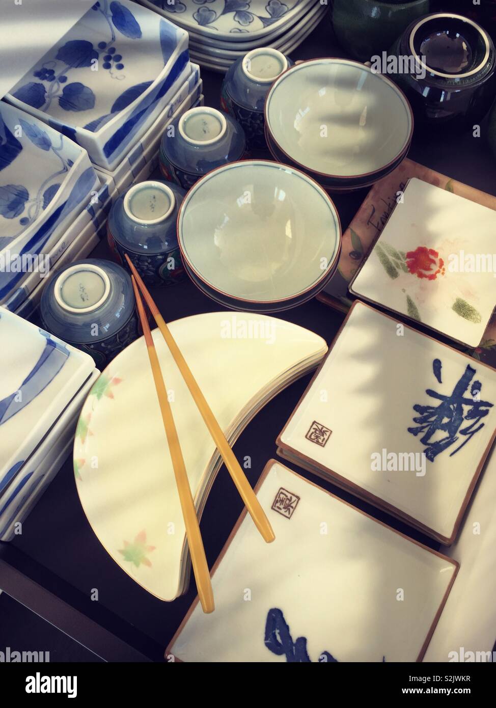 Japanese ceramic plates  and bowls   With chopsticks close up - Smartphone Captured Stock Image