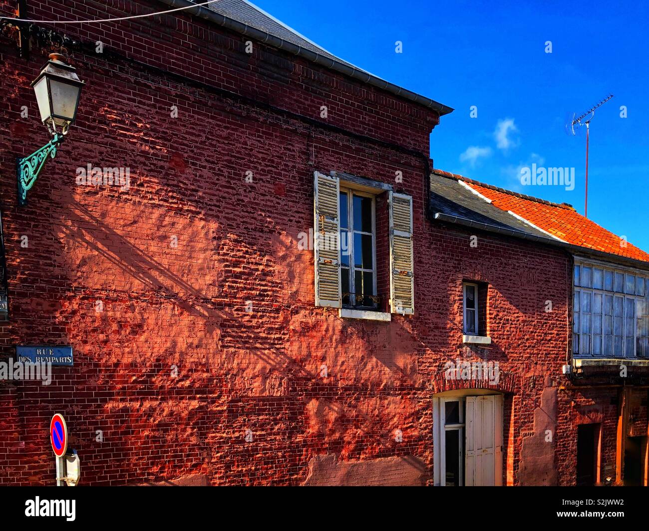 Building in Rue, Normandy, France, lit by early morning sunlight. Rue Des Remparts. Stock Photo