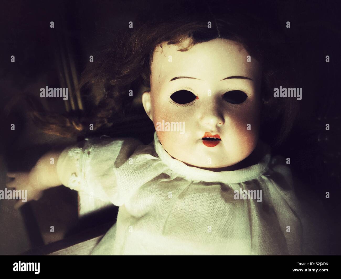 Creepy antique German baby doll with missing eyes Stock Photo