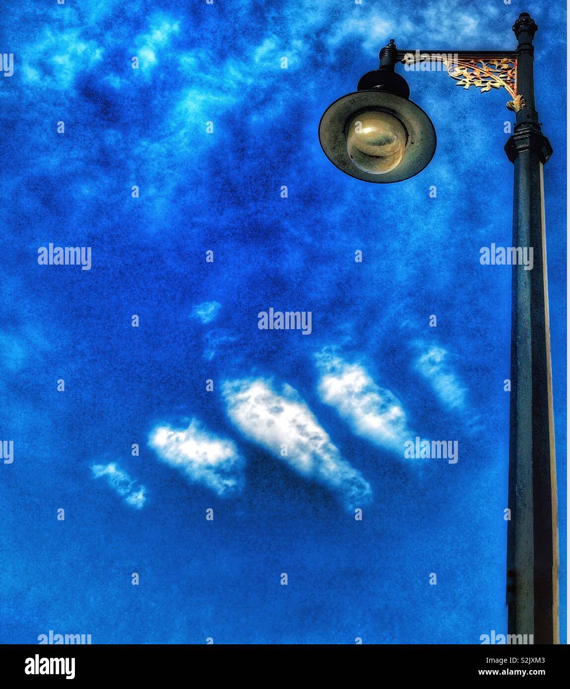 Lamp post blue sky and white clouds. - Smartphone Captured Stock Image