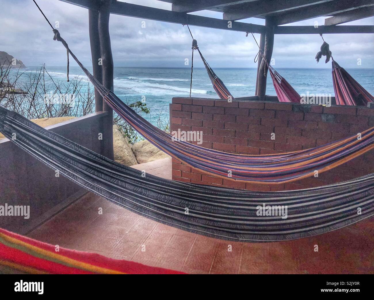 Your choice of hammock overlooking the sea in Tayrona National Park in Santa Marta, Colombia. - Smartphone Captured Stock Image