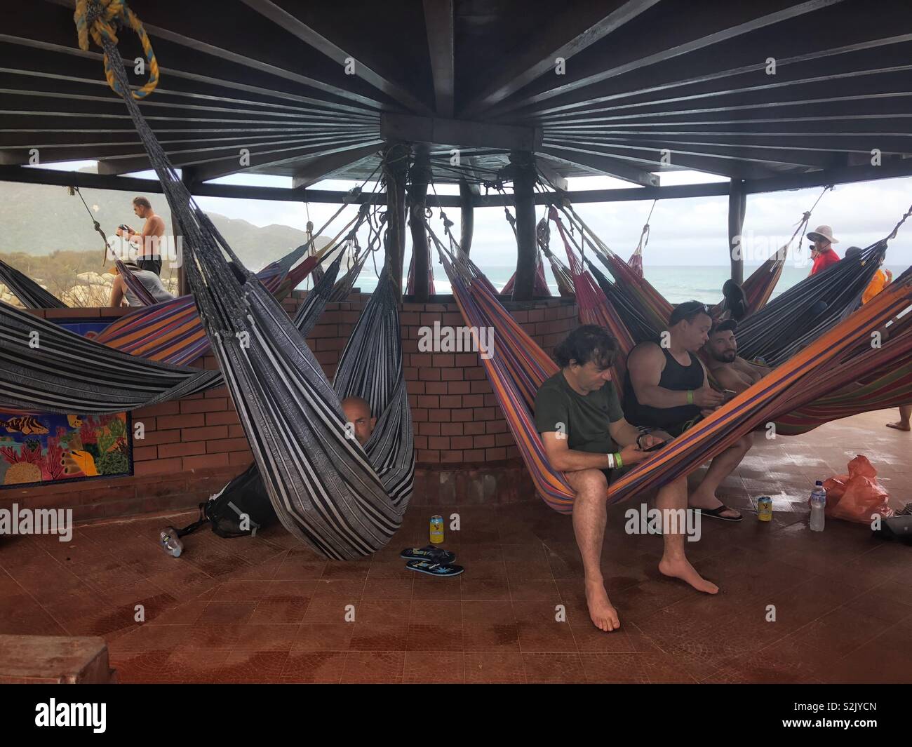 People hanging out in hammocks in Tayrona National Park, Santa Marta, Colombia Stock Photo