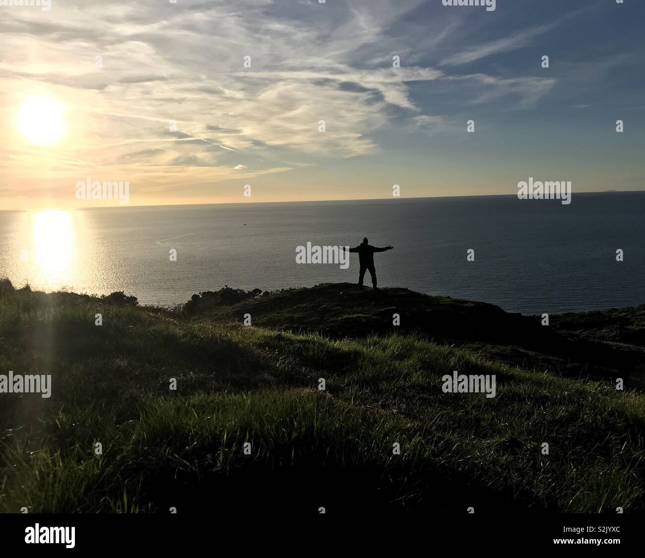 Walking the coastal path in wales at sunset Stock Photo