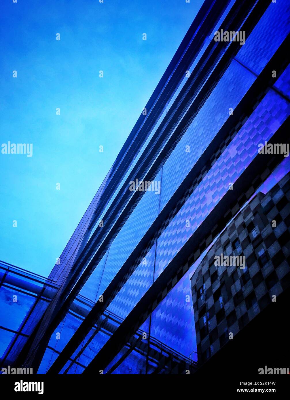 Modern glass city building reflecting evening sky Stock Photo