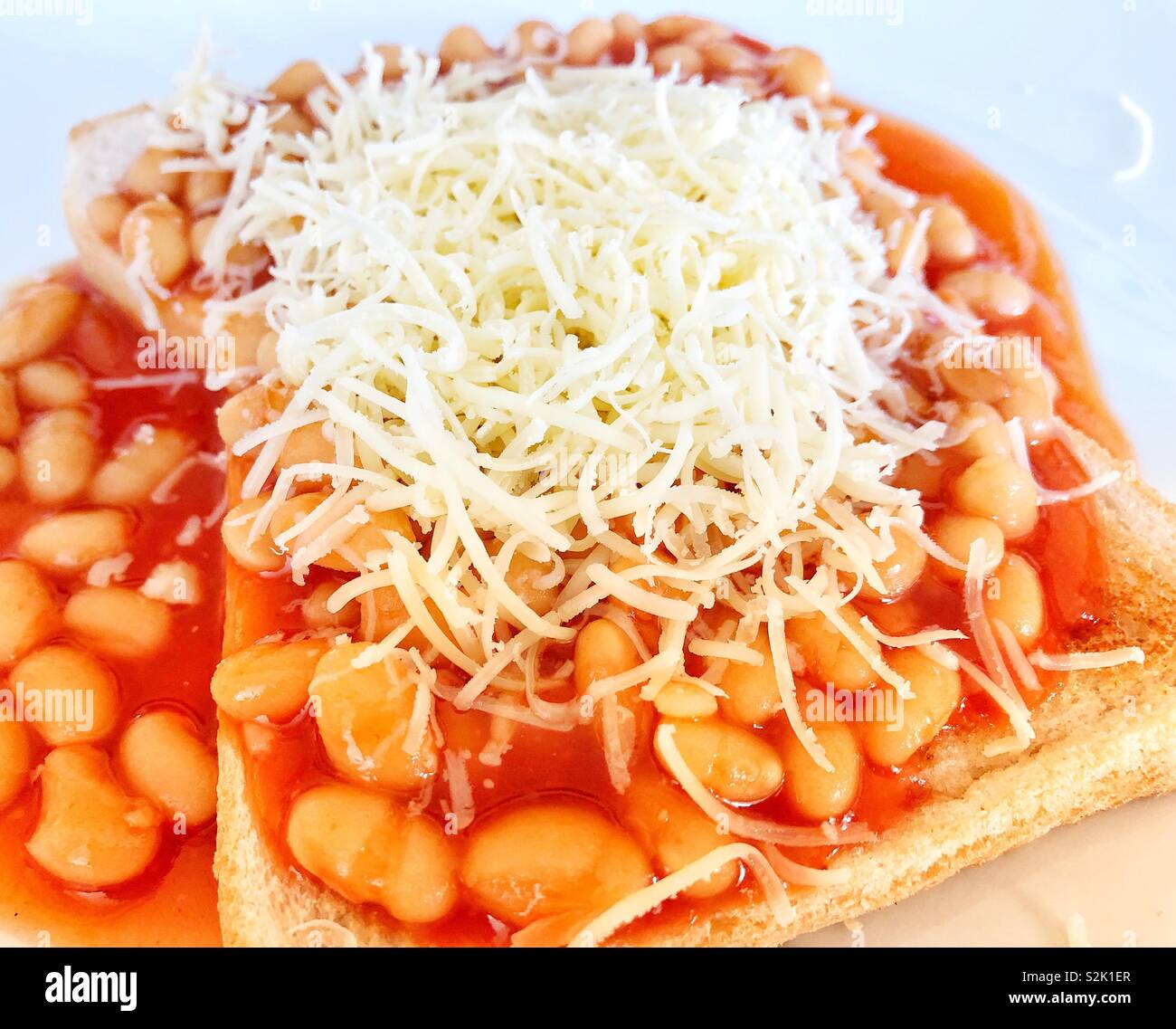 Beans on toast with cheese Stock Photo