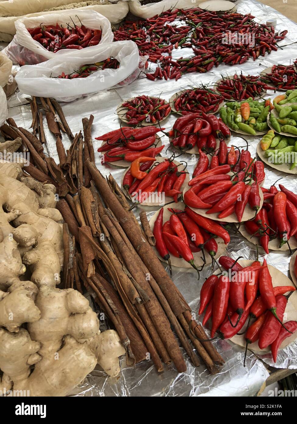 Fresh peppers, cinnamon and ginger for sale at an outdoor market in Rio de Janeiro, Brazil. - Smartphone Captured Stock Image