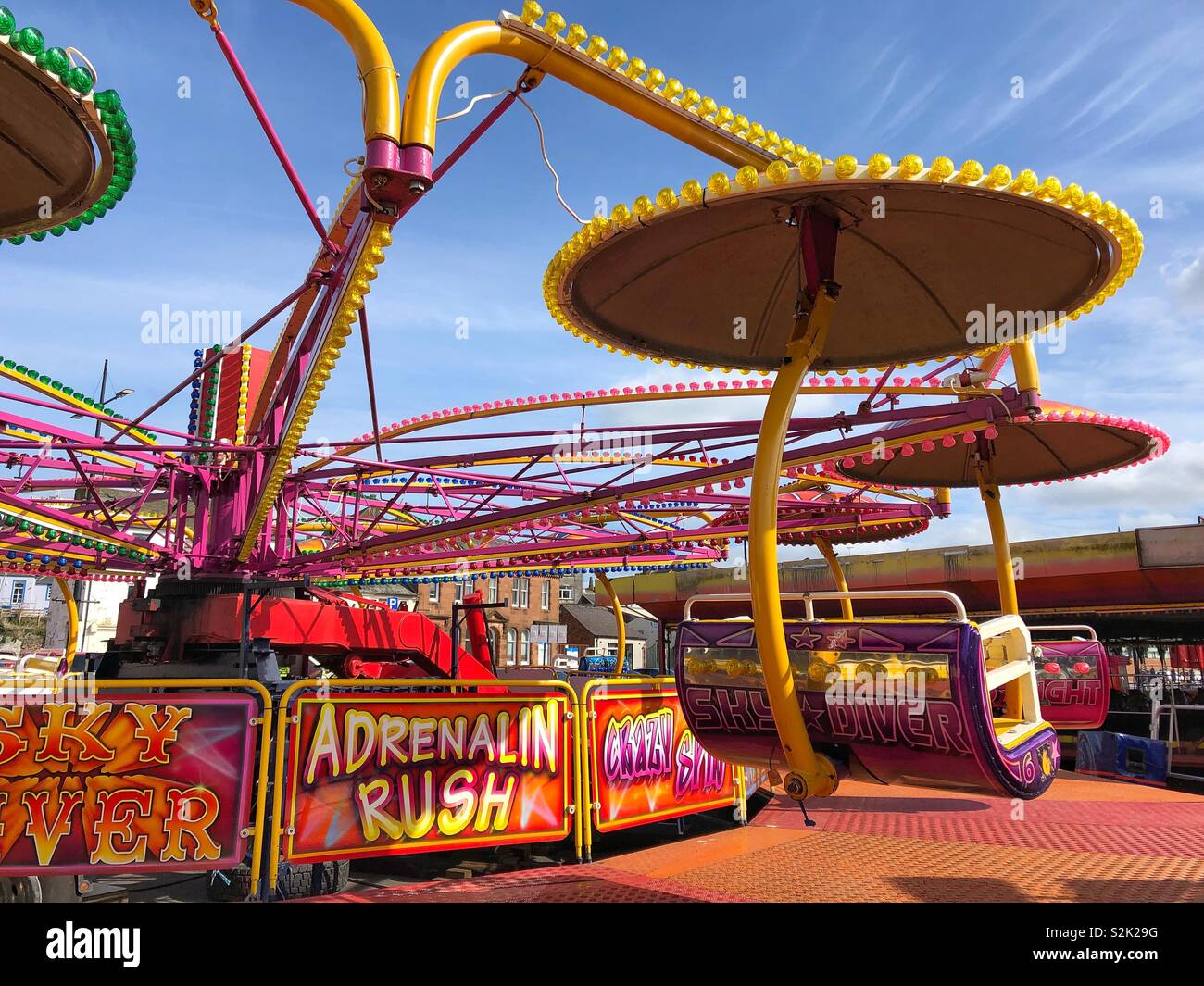 One of the fairground attractions at the Rood Fair on the Whitesands, Dumfries town centre, Scotland.  A sunny day make the bright colours stand out. - Smartphone Captured Stock Image