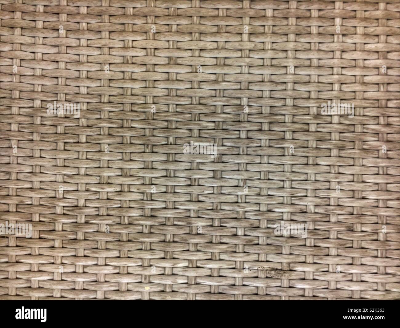 Full frame for a standard horizontal beige wicker basket weave. - Smartphone Captured Stock Image