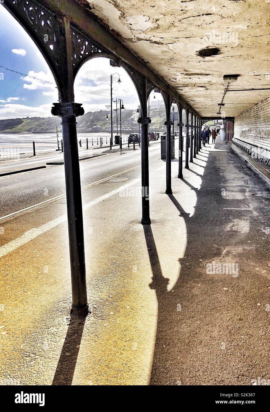 Covered walkway with decorative ironwork on Foreshore Road, Scarborough, UK - Smartphone Captured Stock Image