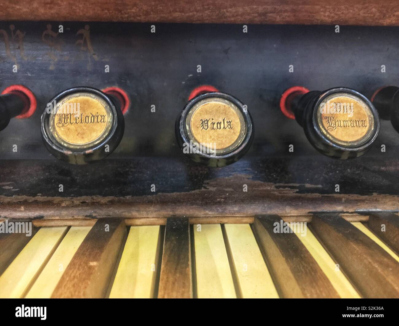 Dor Logan’s, melodic, viola keys prominently displayed on an antique organ console keyboard of an old wooden organ. - Smartphone Captured Stock Image