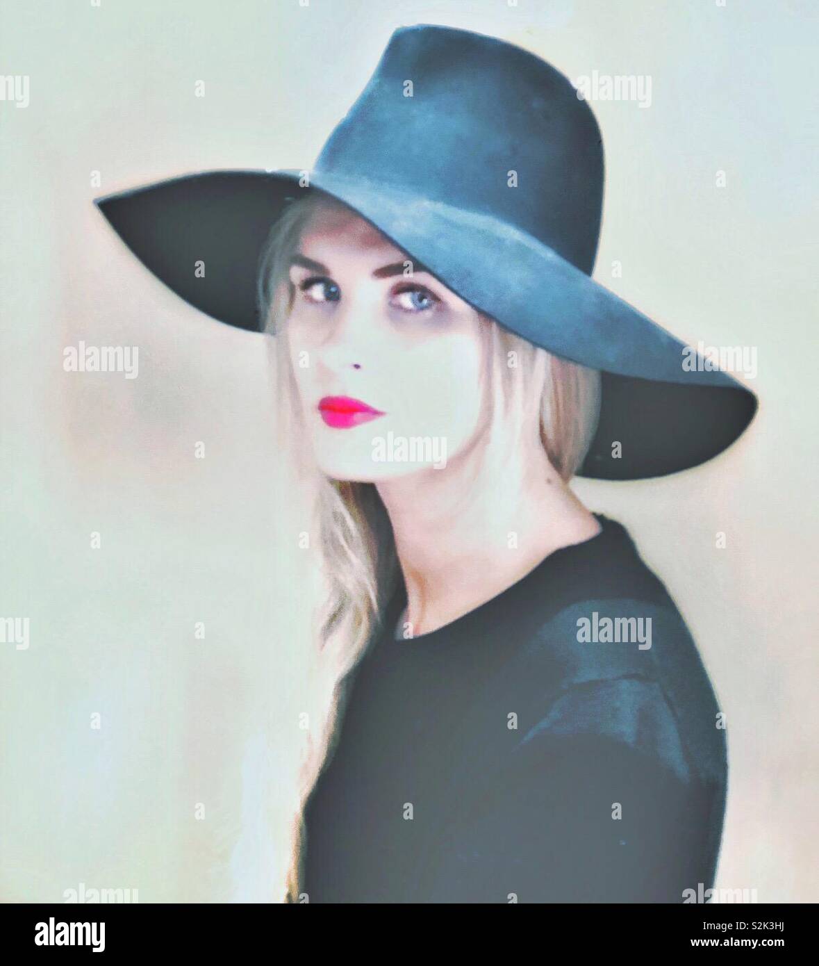 A fashionable blonde woman in a floppy hat. - Smartphone Captured Stock Image
