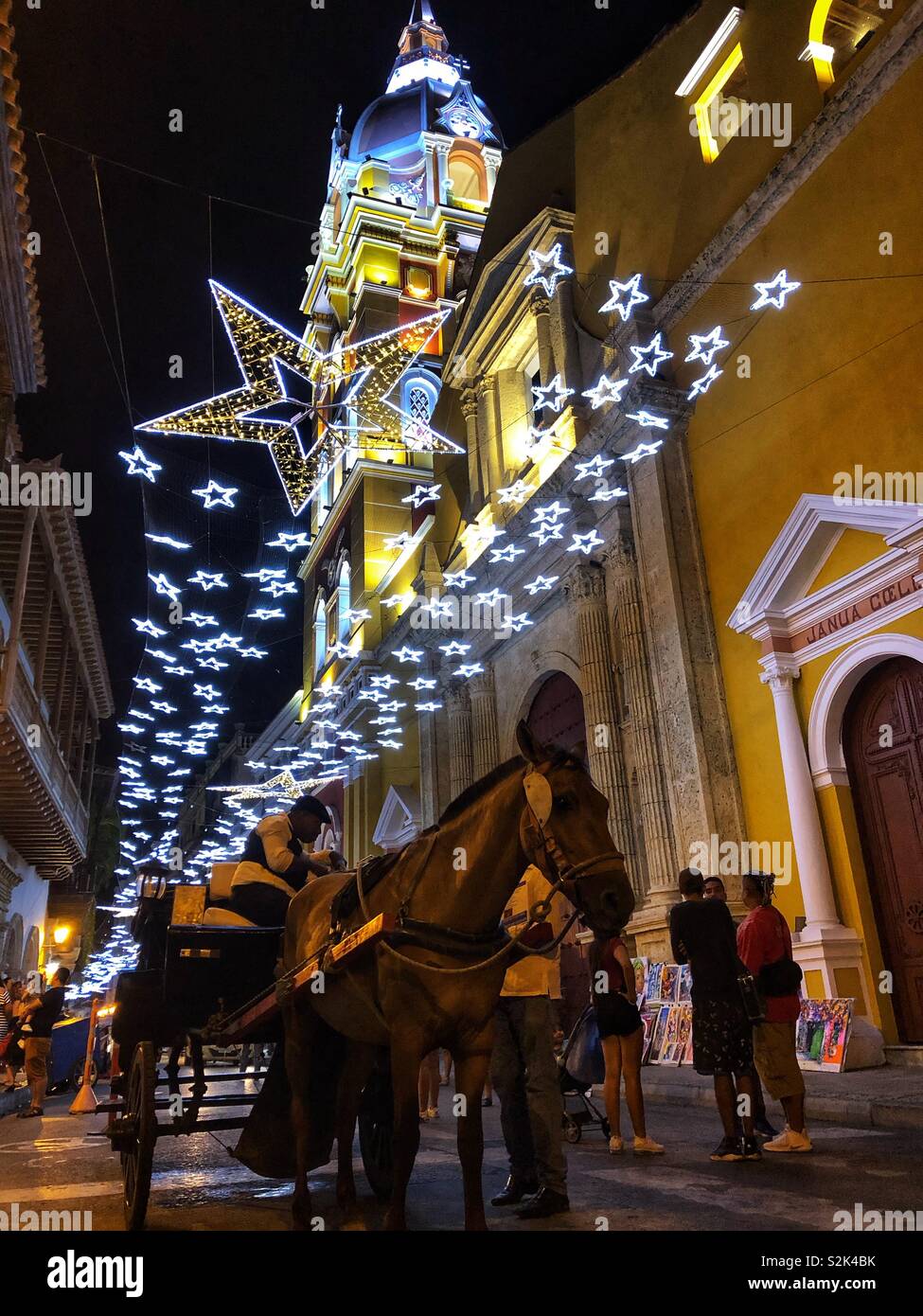 Horse and carriage ride in Old Town Cartagena, Colombia at night. - Smartphone Captured Stock Image