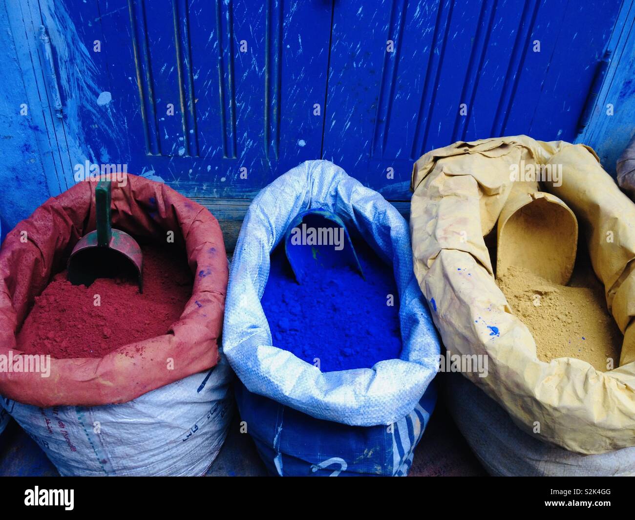 Bags of powdered pigments: red, blue and yellow - primary colours. Stock Photo