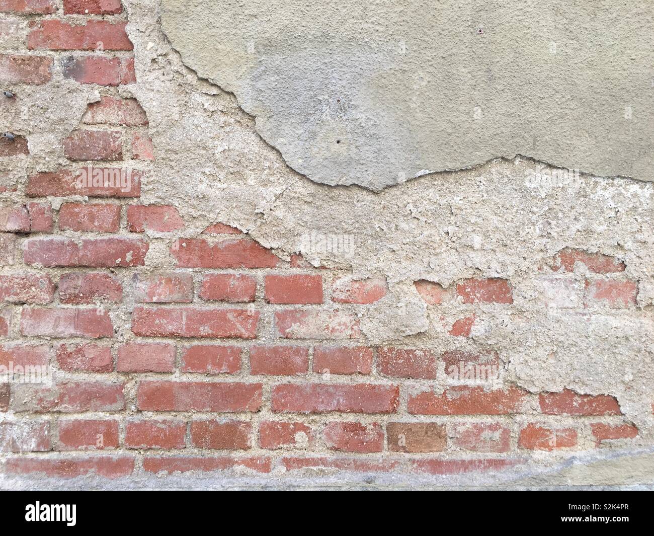 Plastered wall with exposed brickwork Stock Photo Alamy
