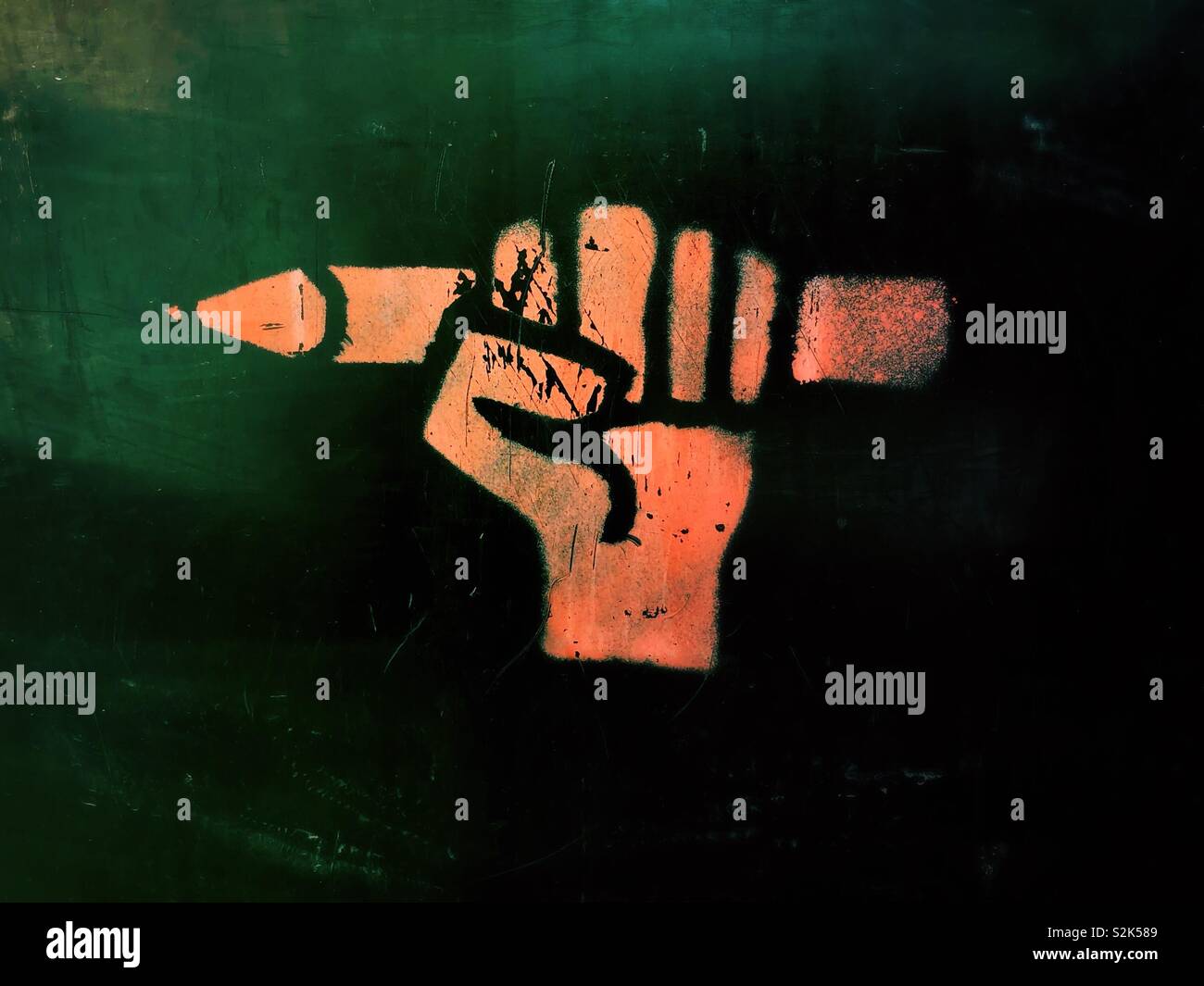 Fist holding a pencil graffiti, freedom of speech concept - Smartphone Captured Stock Image