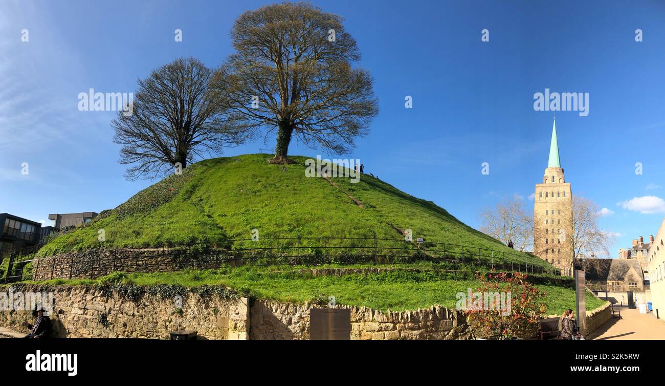 Oxford Castle Mound (or Norman motte) with trees and people on the mound with Nuffield College Library Tower. Stock Photo