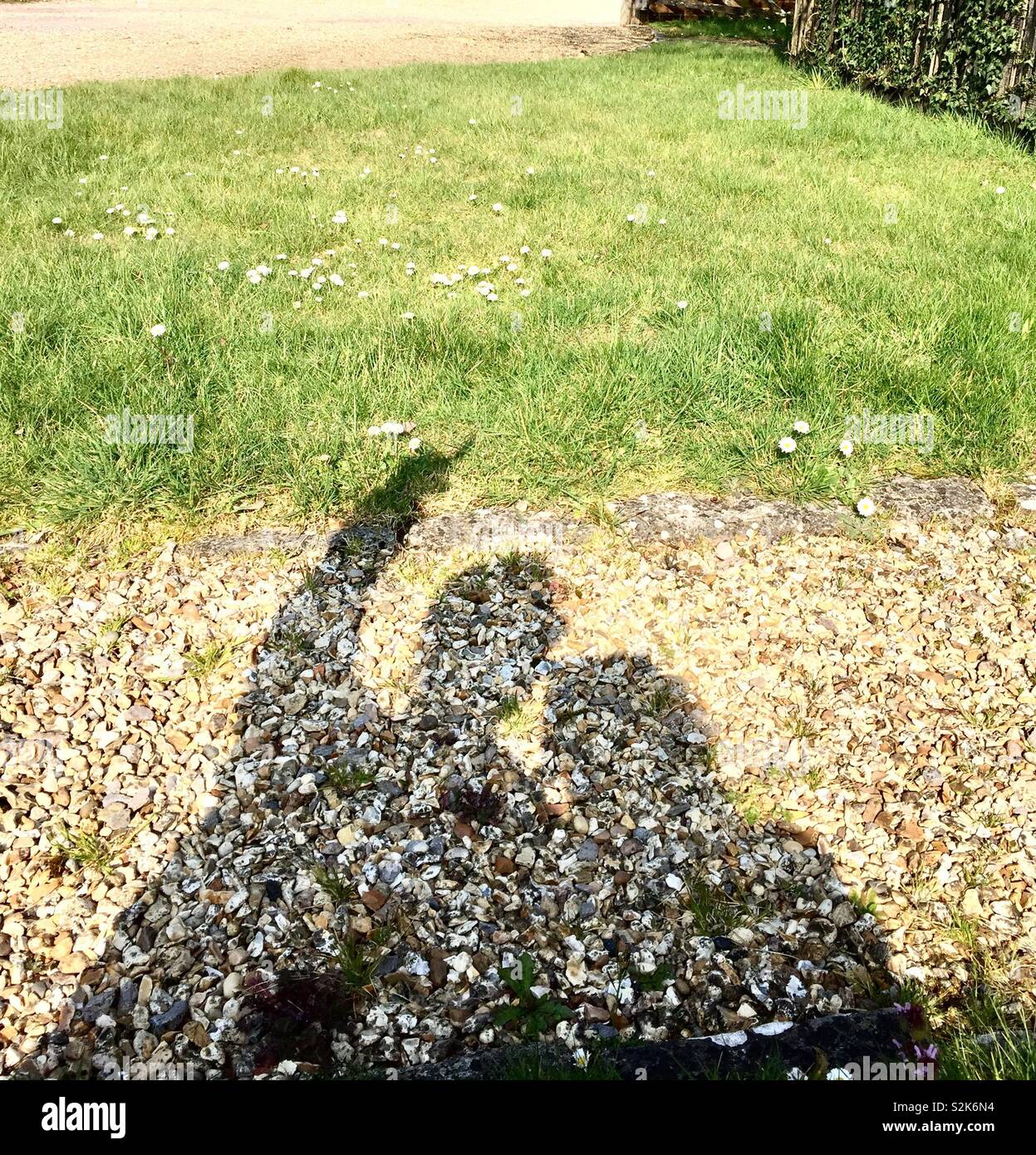 Two peoples shadow on the ground with on pointing Stock Photo