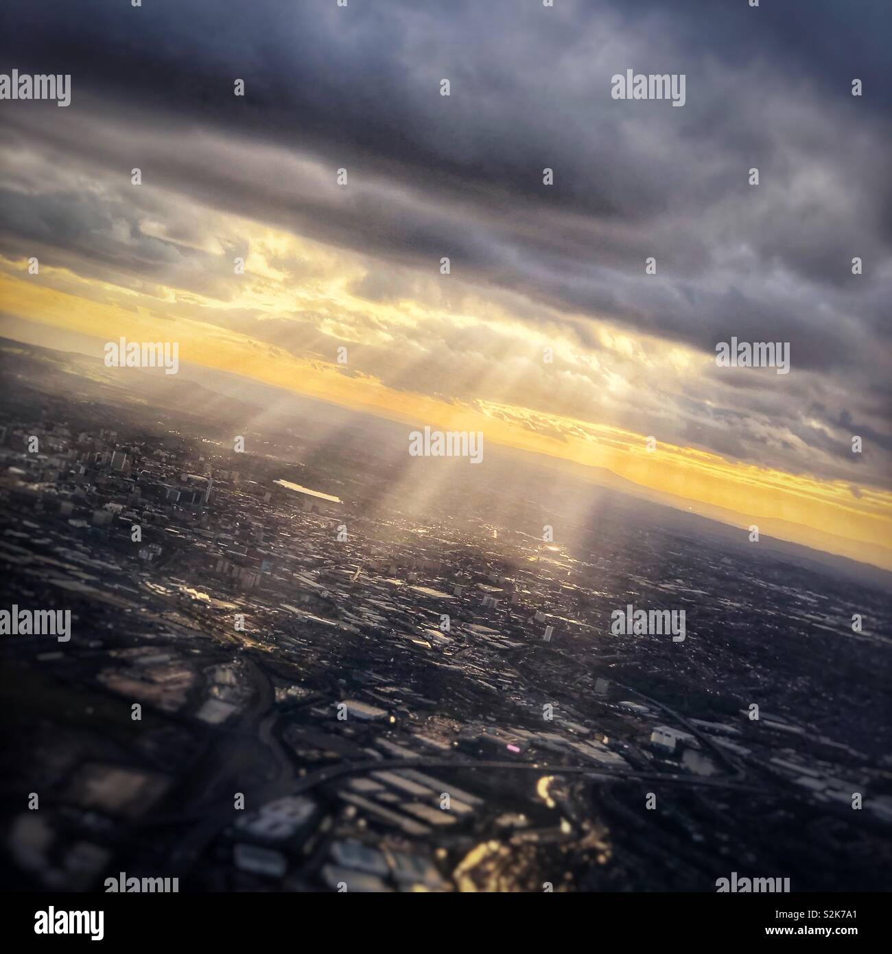 Birmingham town lit by golden crepuscular rays through a cloud - Smartphone Captured Stock Image