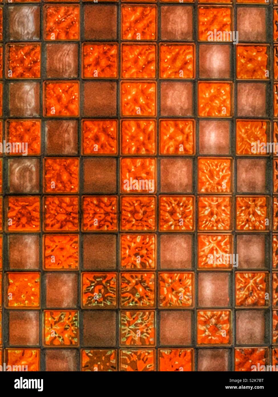 Full frame of a translucent orange backlit glass block wall. - Smartphone Captured Stock Image