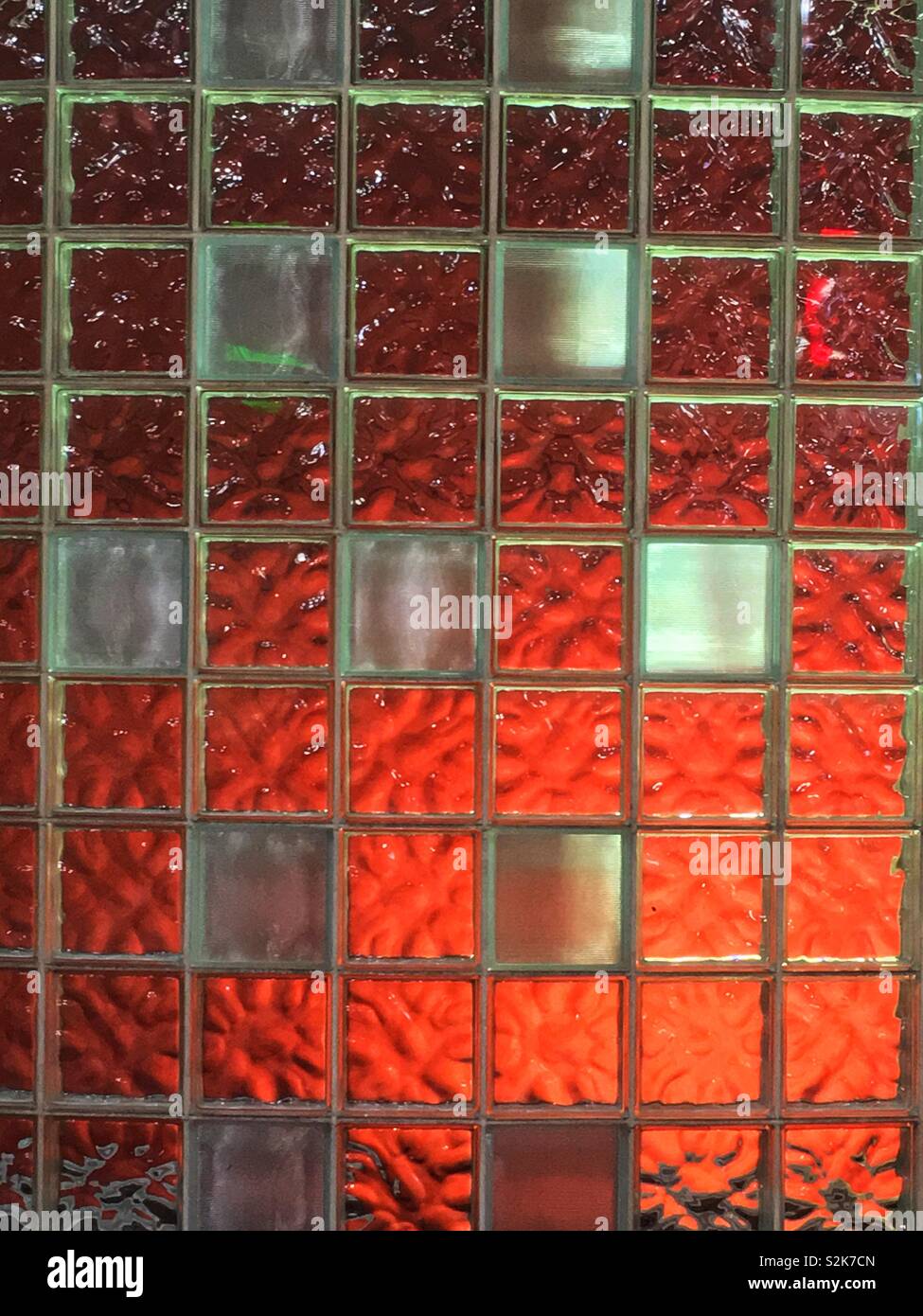 Full frame of a backlit orange translucent glass block wall. - Smartphone Captured Stock Image