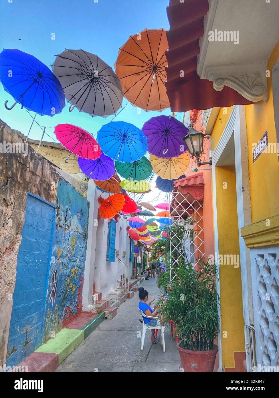 A narrow colourful street in the Getsemani neighbourhood in Cartagena ...