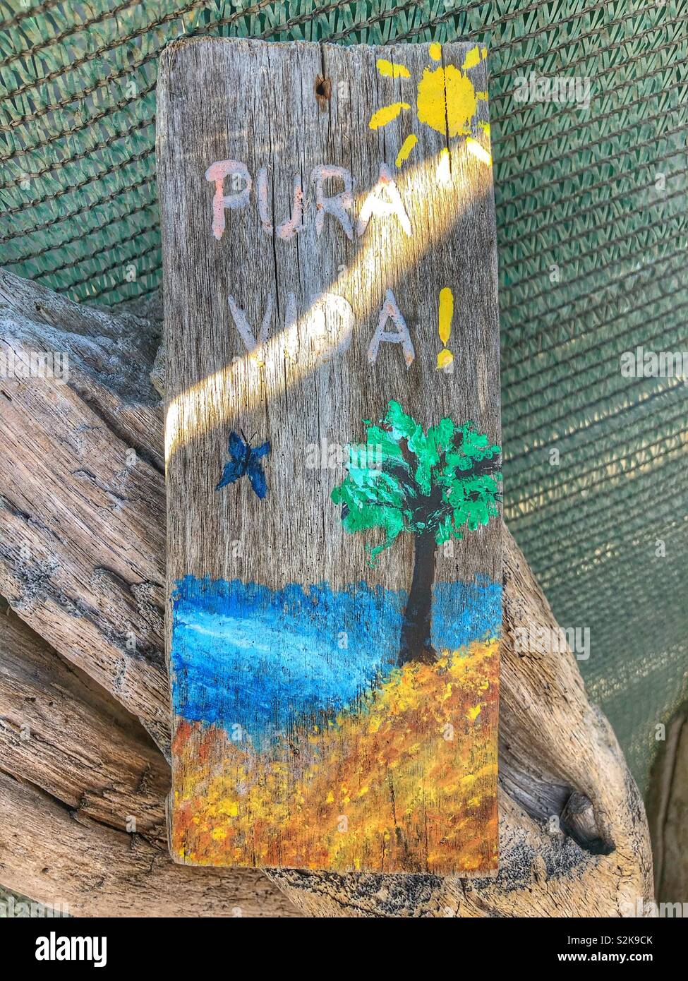 A hand painted wooden sign in Spanish. - Smartphone Captured Stock Image