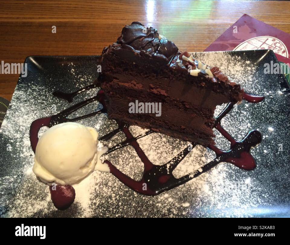 Chocolate fudge cake with vanilla ice cream and chocolate sauce dessert Stock Photo