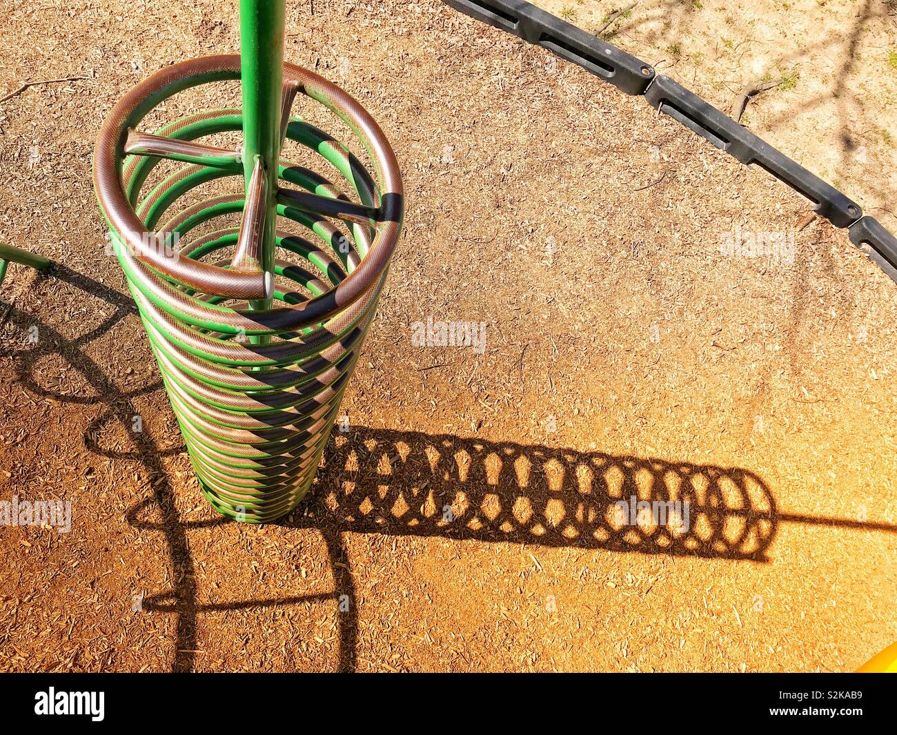 Spiral “steps” at a playground, with shadows - Smartphone Captured Stock Image