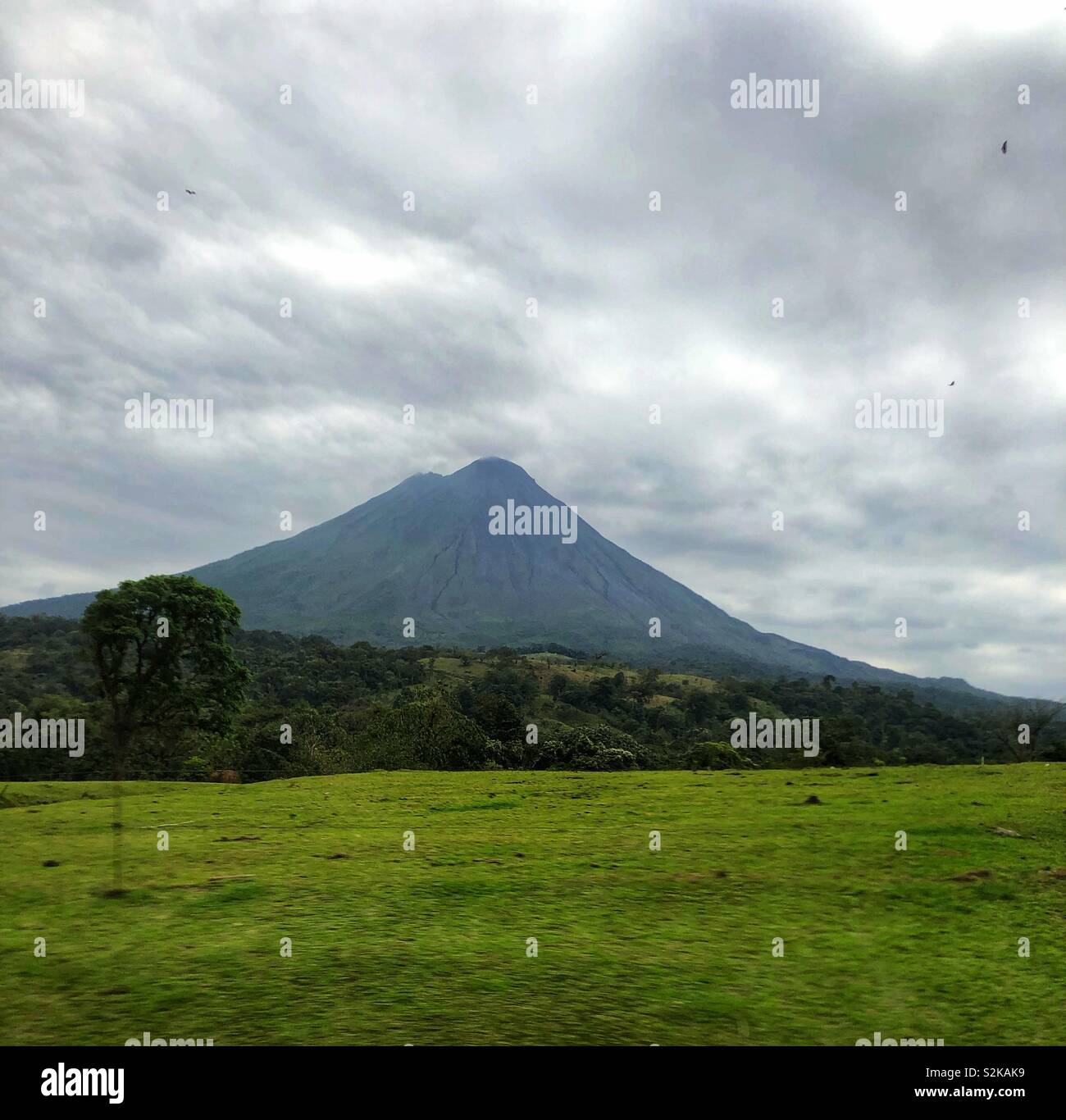 Arenal Volcano in Costa Rica seen from a moving vehicle. - Smartphone Captured Stock Image