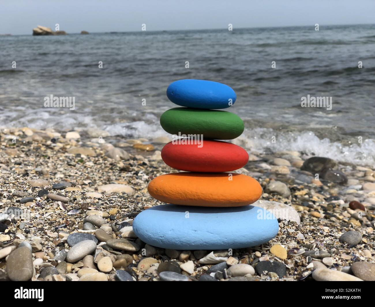 Stack of colored stones with sea background - Smartphone Captured Stock Image