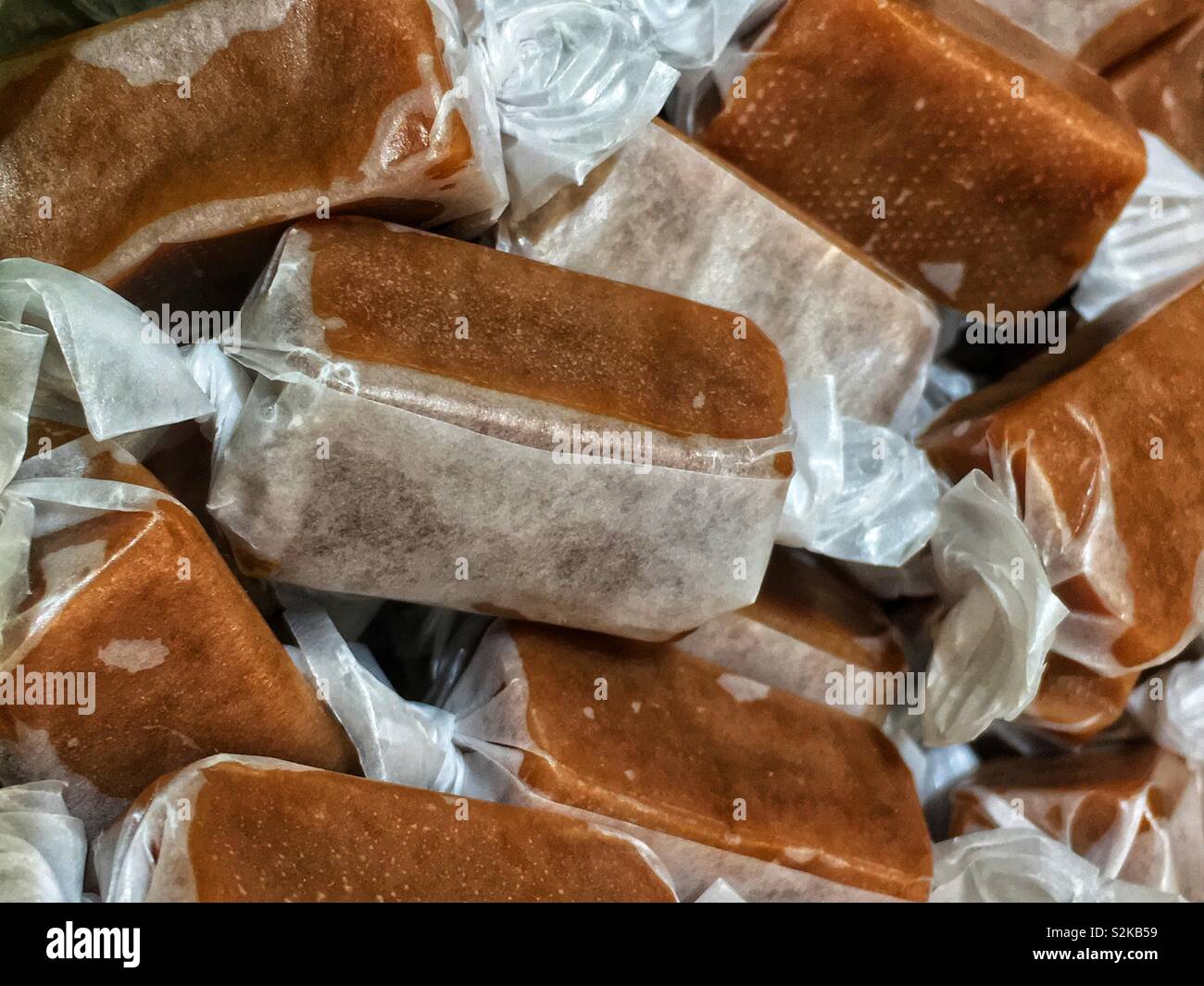 Full frame of fresh delicious homemade individually wrapped caramel candies. - Smartphone Captured Stock Image Full frame of fresh delicious homemade individually wrapped caramel candies. - Smartphone Captured Stock Image