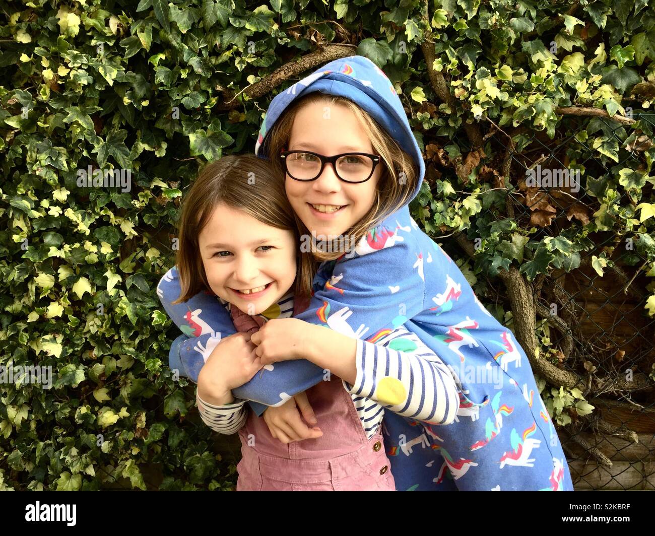 Two sisters having a cuddle - Smartphone Captured Stock Image