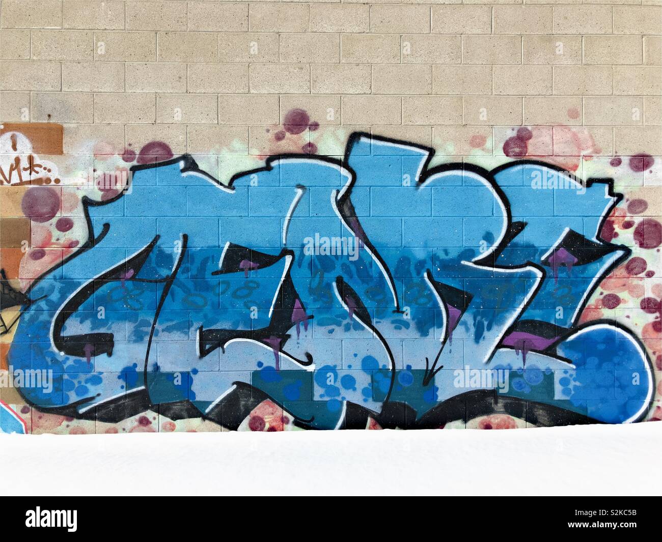 Graffiti on tan wall. Stock Photo