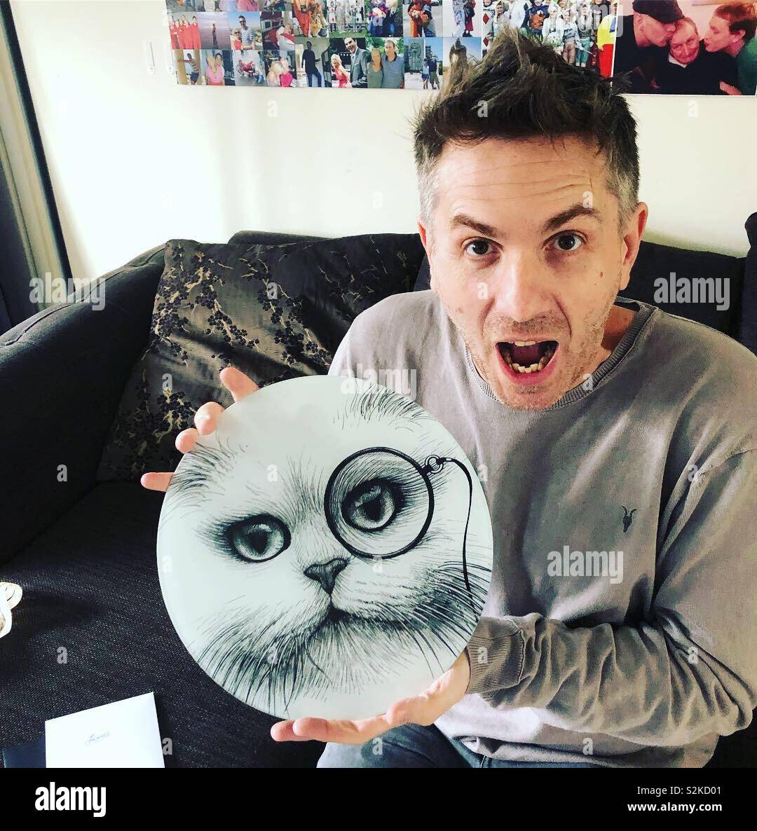 Man holding Rory Dobner monocled cat with mouth open - Smartphone Captured Stock Image