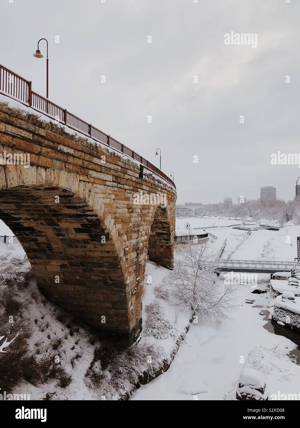 Stone bridge fading off into a winter scene. Stock Photo