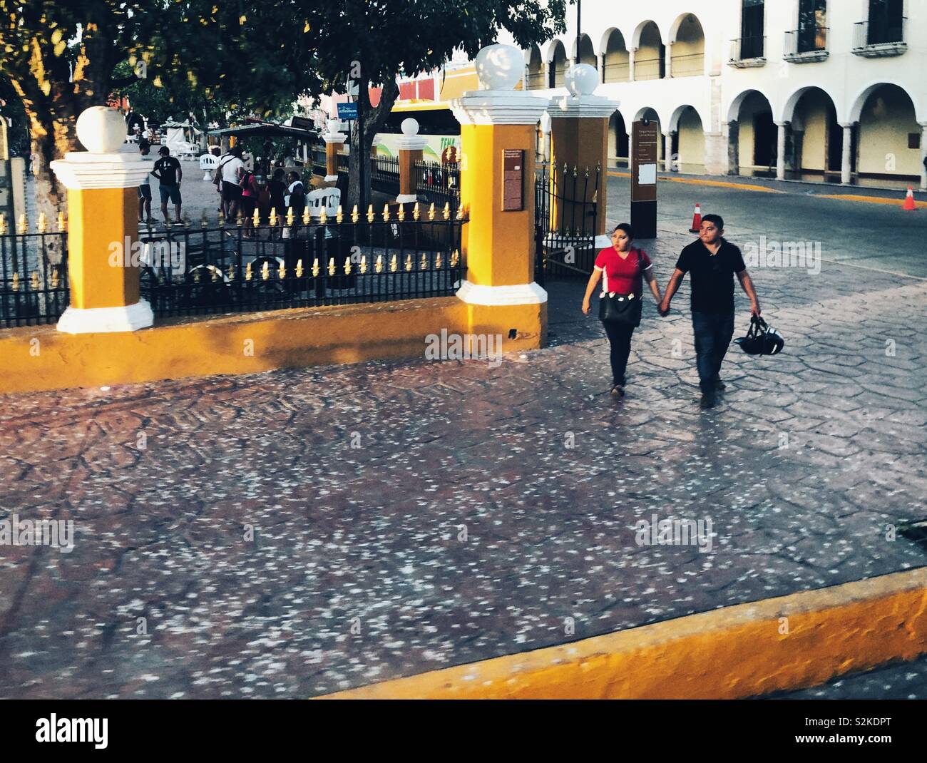Couple walks near Plaza el Parque Francisco Canton in Valladolid, Mexico Stock Photo