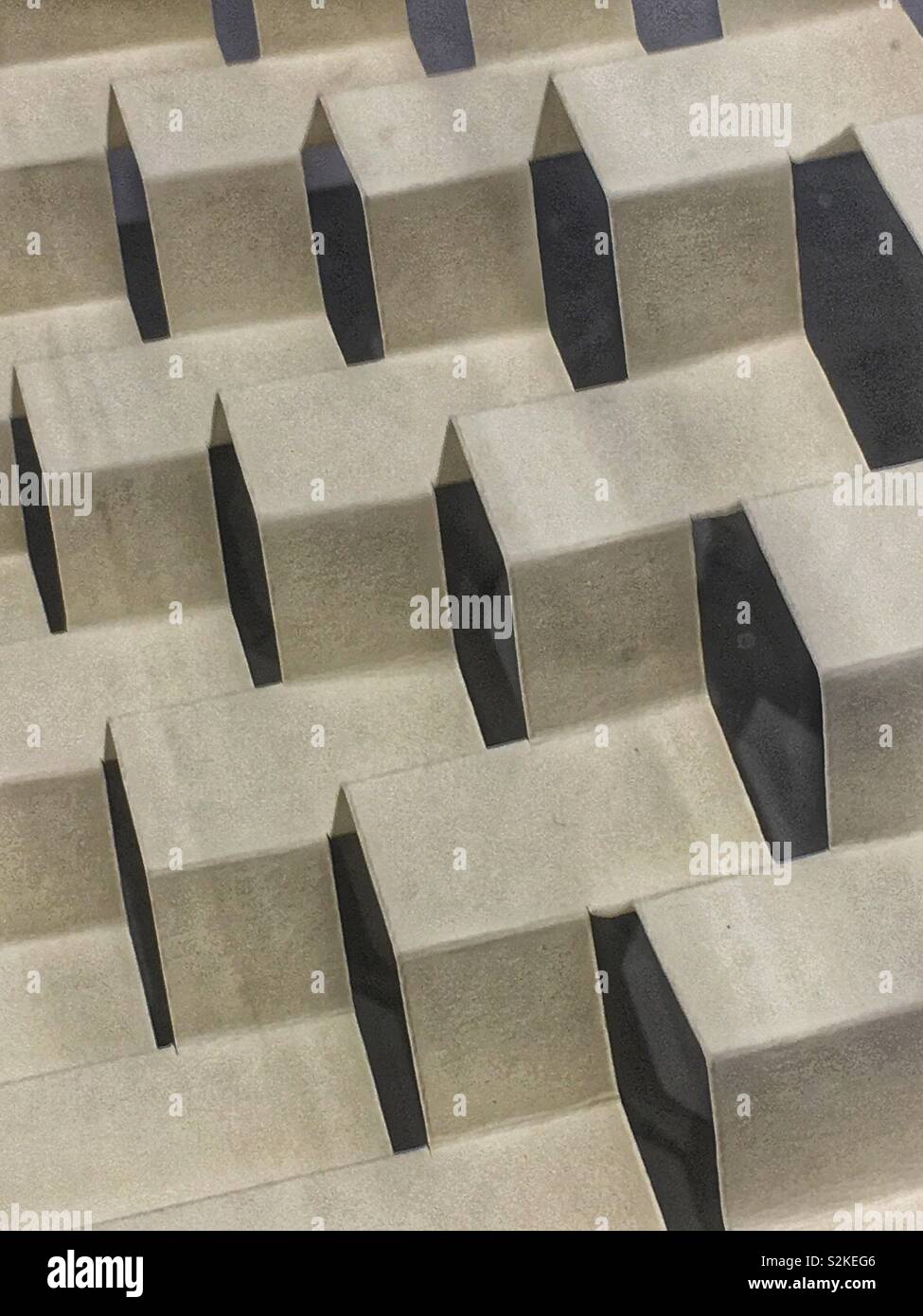 Cardboard folded in a play of light and shadow. - Smartphone Captured Stock Image