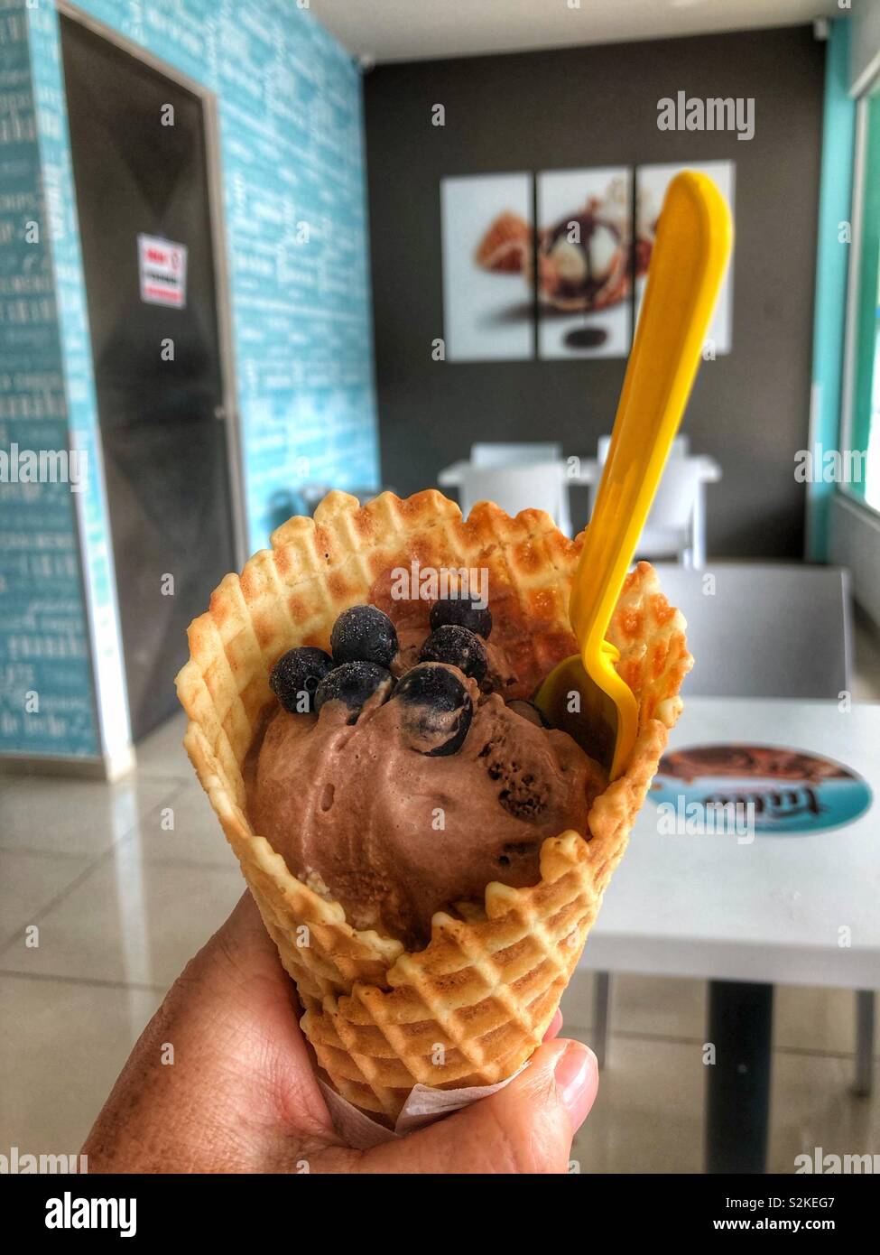 A chocolate and blueberry ice cream cone. - Smartphone Captured Stock Image