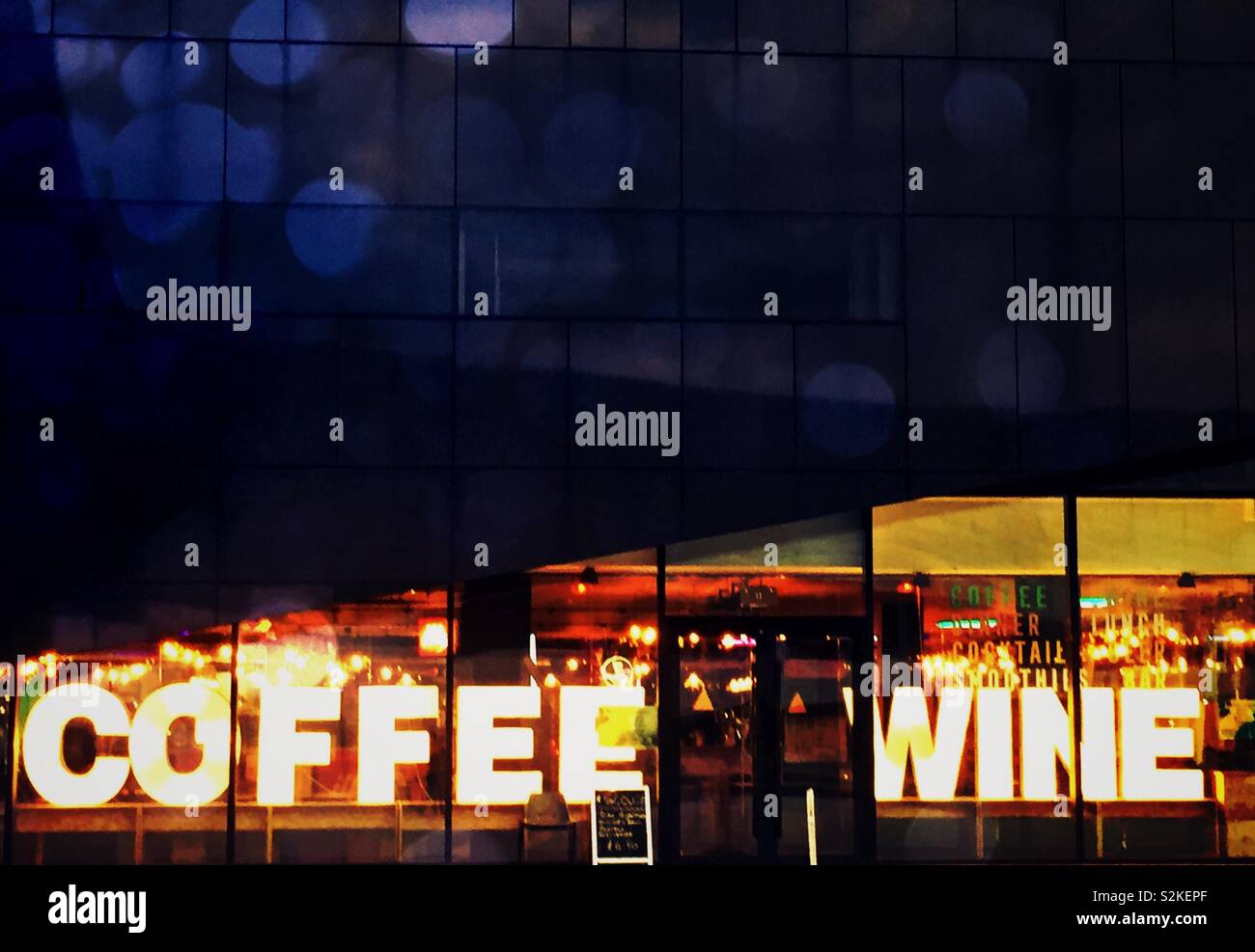 Coffee and wine sign. Coffee shop wine bar lit up at night in city Stock Photo