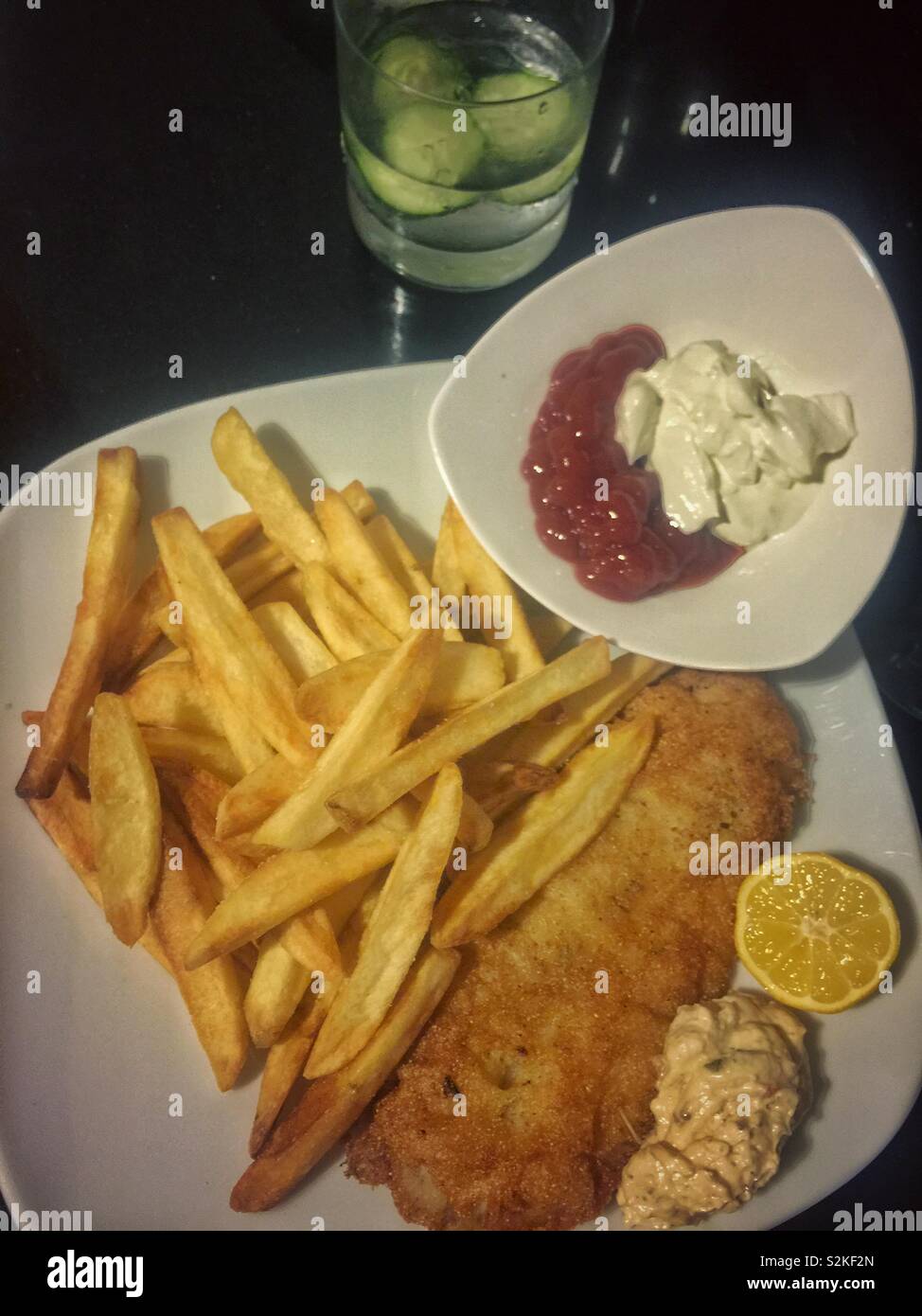 Fried catfish with French fries, ketchup and pickle mustard sauce Stock
