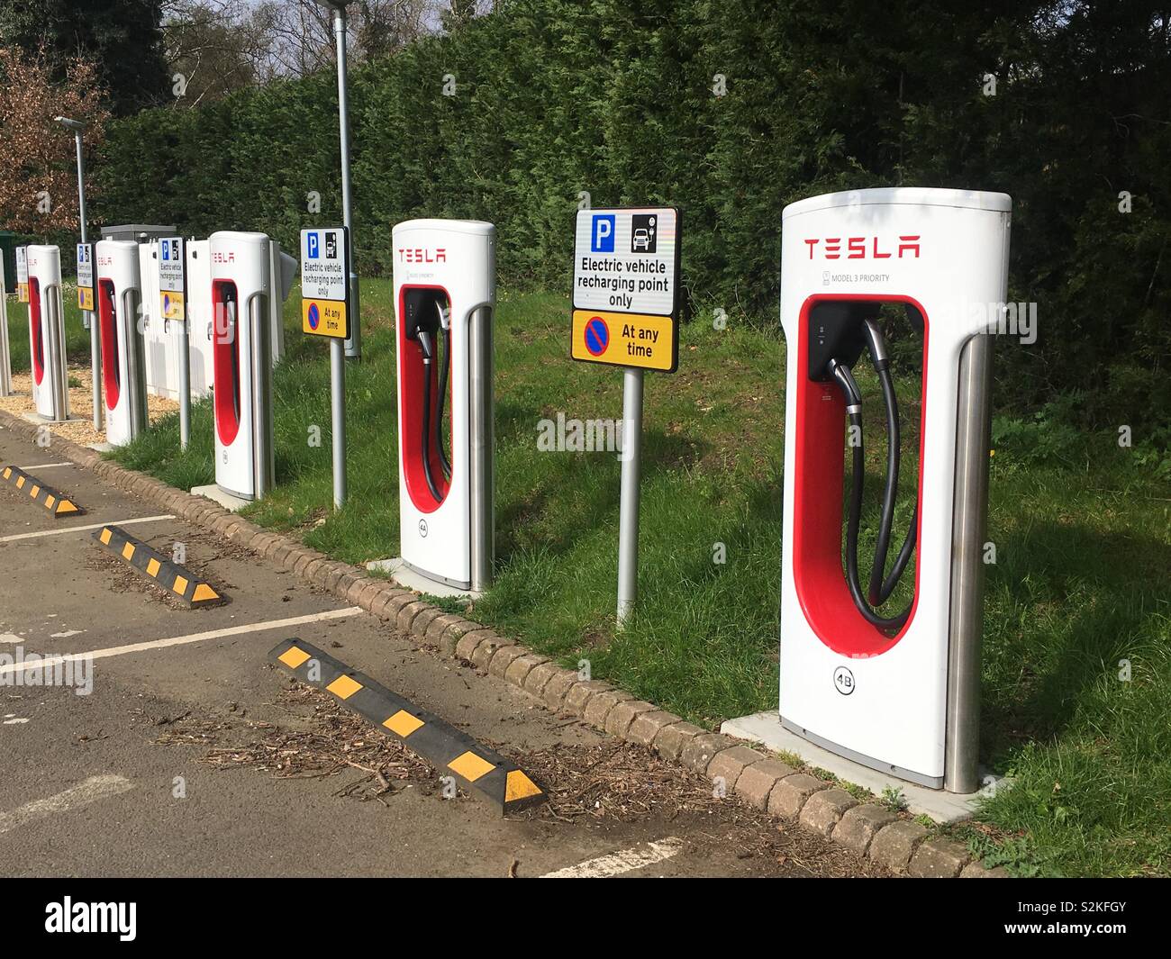 Bank of Tesla electric car charging points in car park Stock Photo Alamy