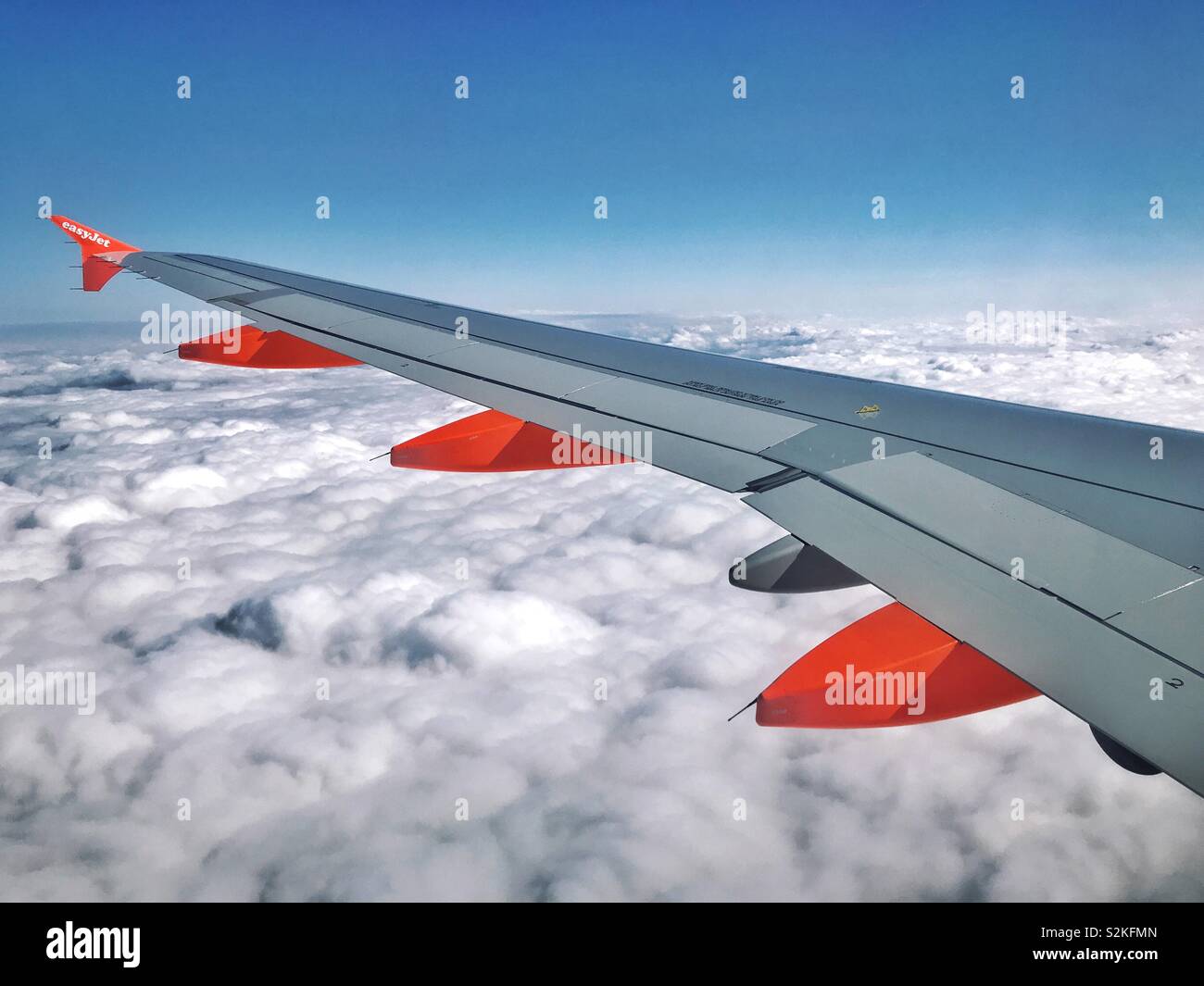 The view out of an EasyJet aircraft window high above Northern Europe. It’s a modern pleasure to travel above the clouds! Photo Credit © COLIN HOSKINS. - Smartphone Captured Stock Image
