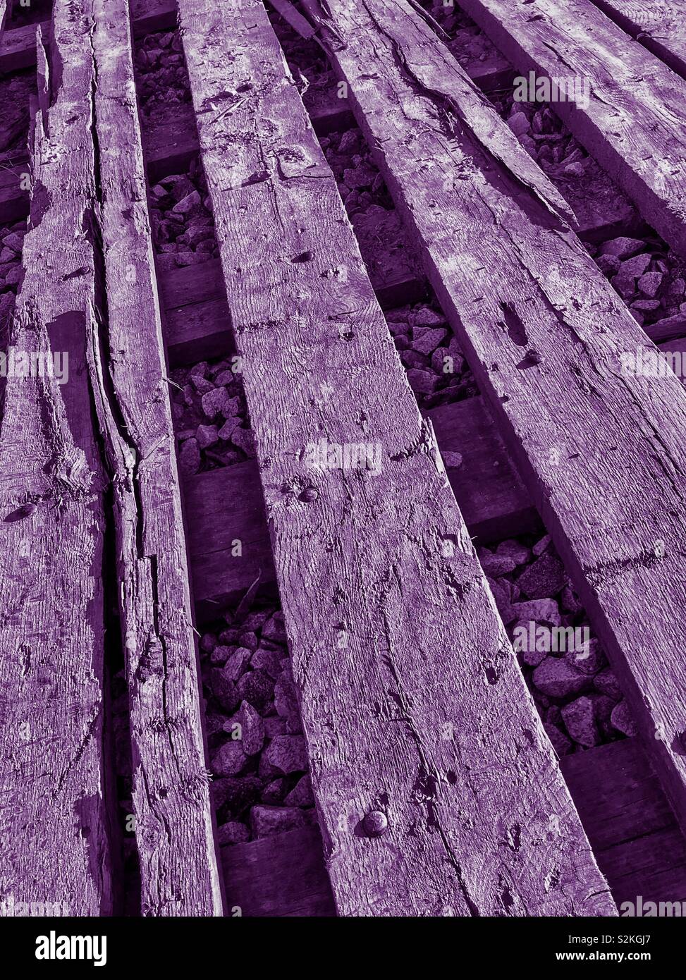 Purple tinted photo of wooden beams placed to shore up driveway for logging operation, North Carolina - Smartphone Captured Stock Image
