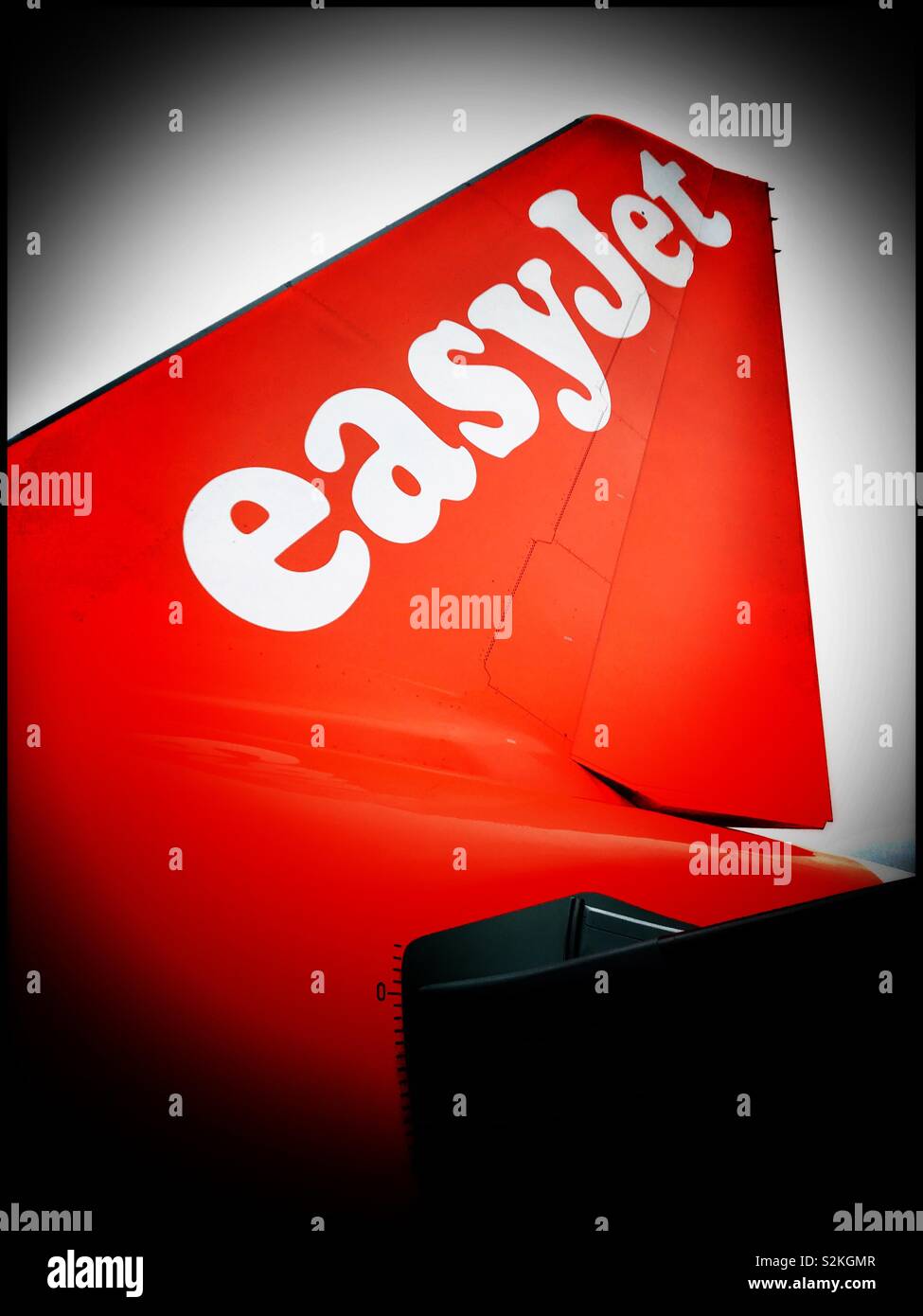 A view looking up at the tail section of an EasyJet Airbus aircraft. EasyJet is one of the most famous European “Budget” airlines. Photo Credit - © COLIN HOSKINS. - Smartphone Captured Stock Image
