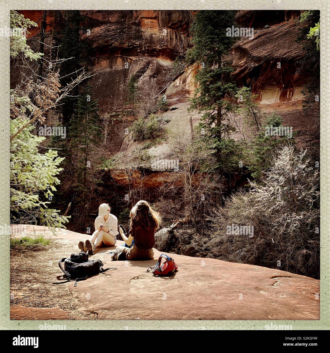 Teen girls pause for a rest on a hiking trail in Sedona, Arizona Stock Photo Alamy