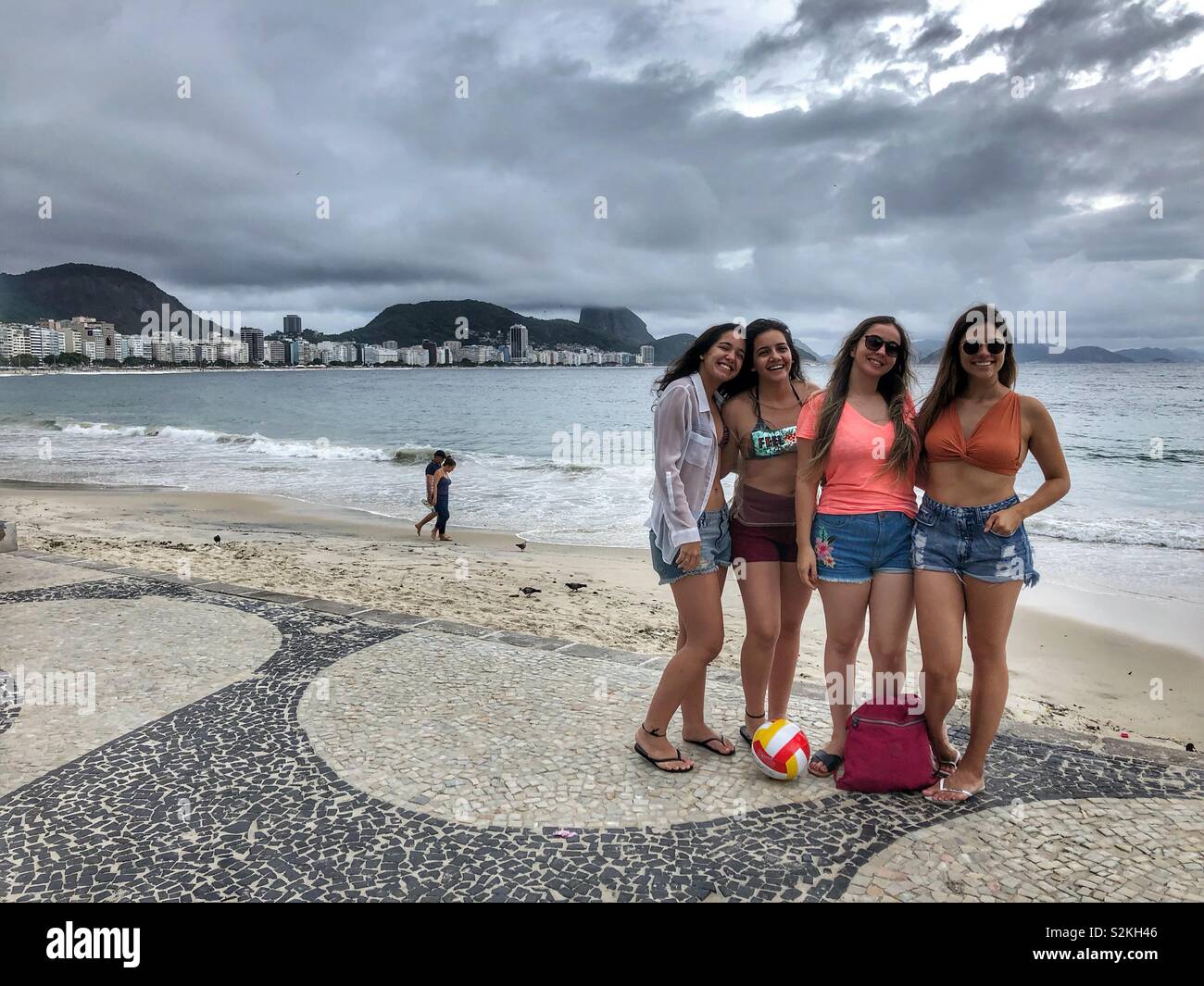 Young women posing on the Copacabana beach walk. - Smartphone Captured Stock Image