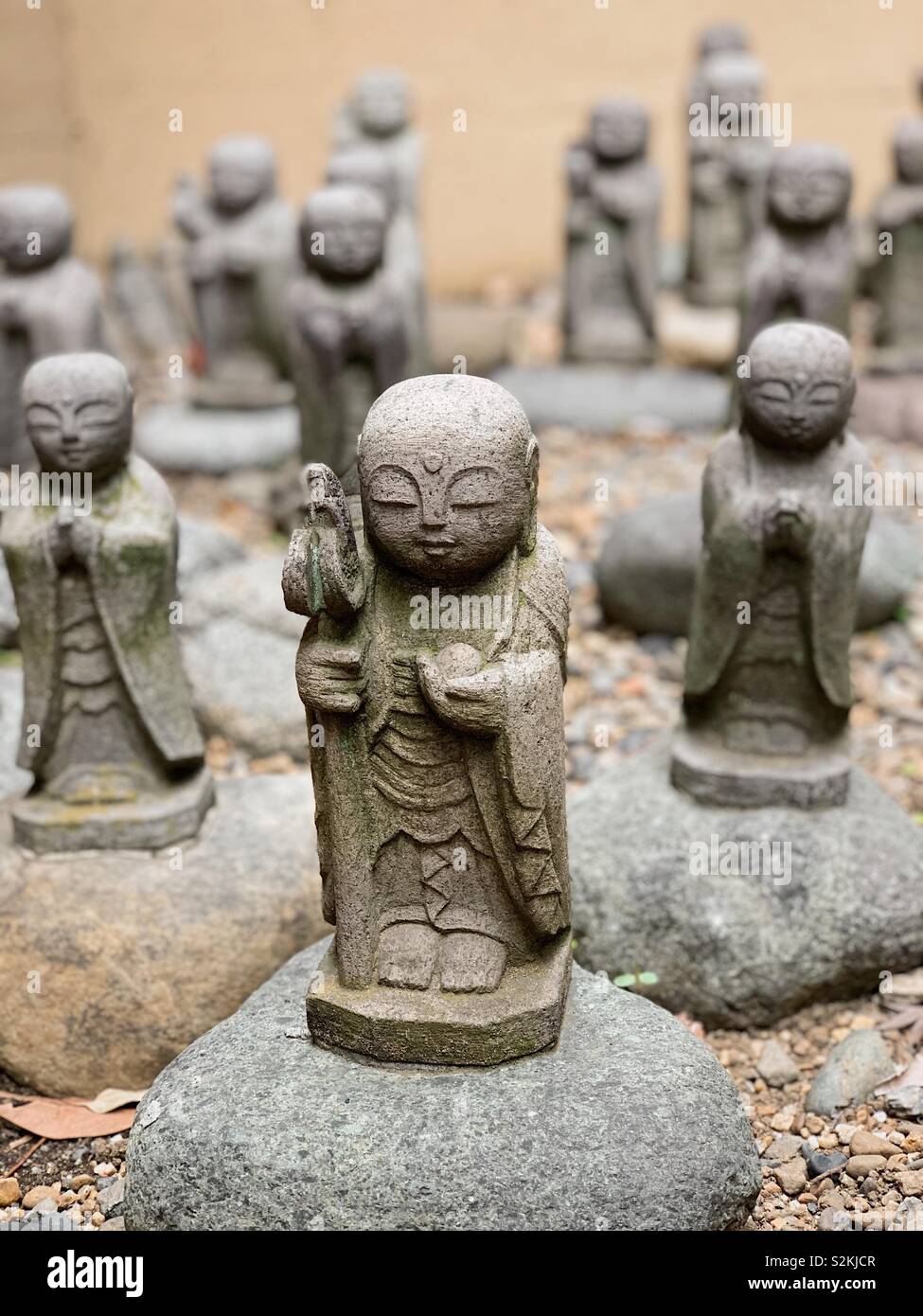 Stone carvings of little monks at a Buddhist temple in Tokyo Japan - Smartphone Captured Stock Image