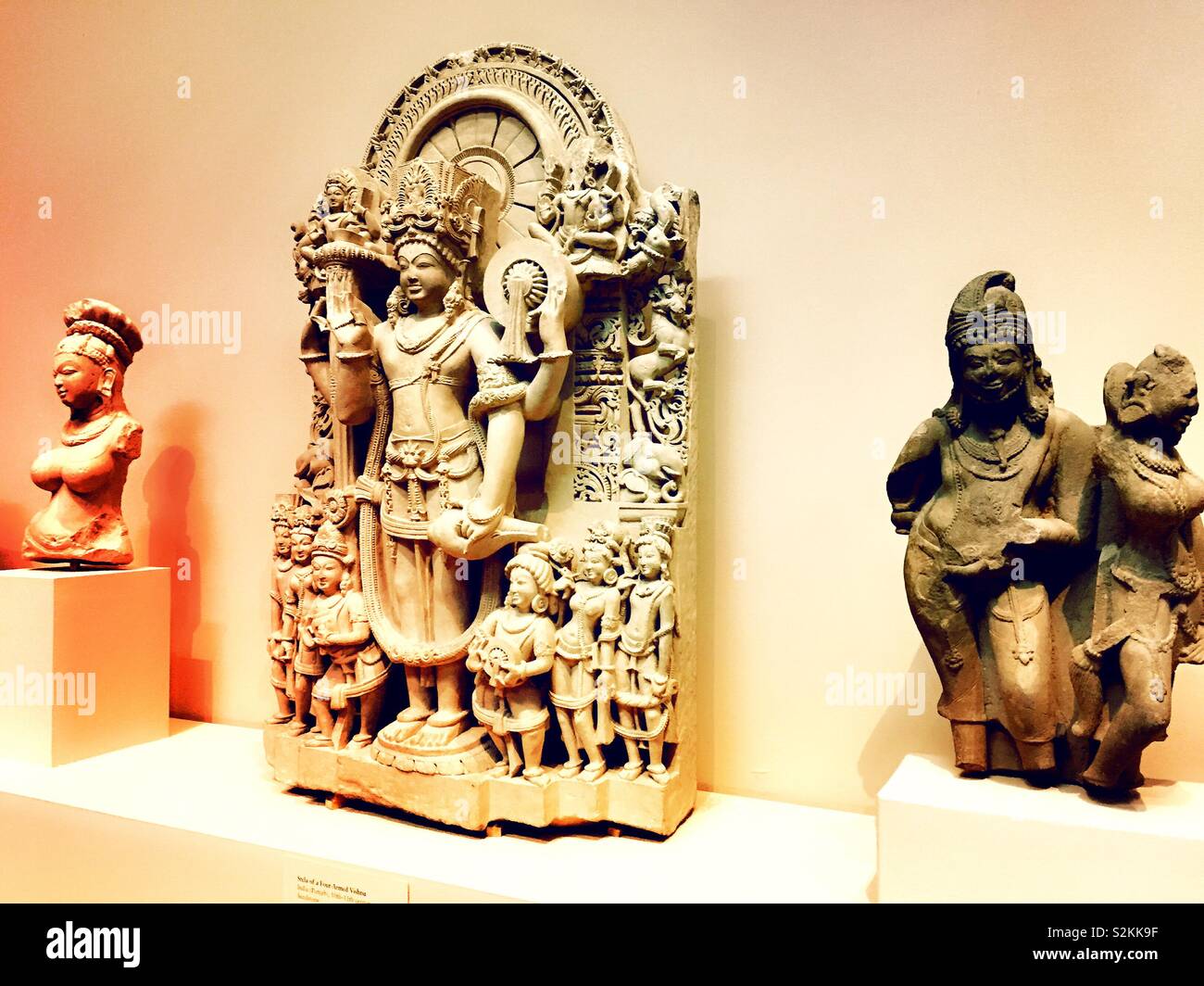 Sandstone sculptures of Buddhism in the Asian art wing of the Metropolitan Museum of Art, NYC, USA - Smartphone Captured Stock Image