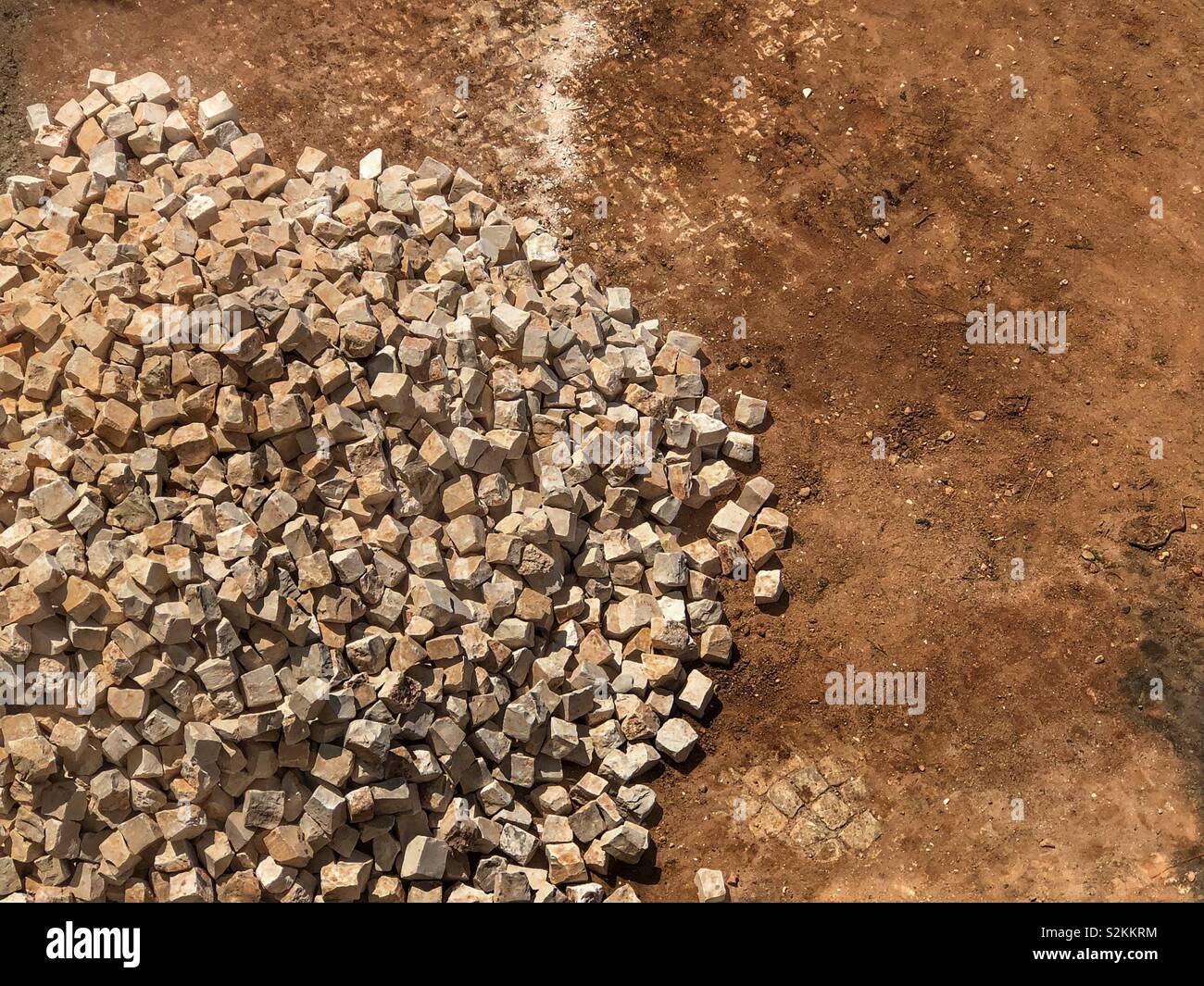 Pile of rocks ready to make the Portuguese style of paving called Calcada - Smartphone Captured Stock Image